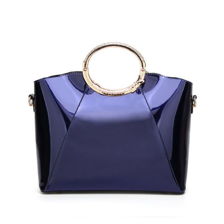 Damen Handtasche mit glänzender Oberfläche und floralem Anhänger Nord Taschen