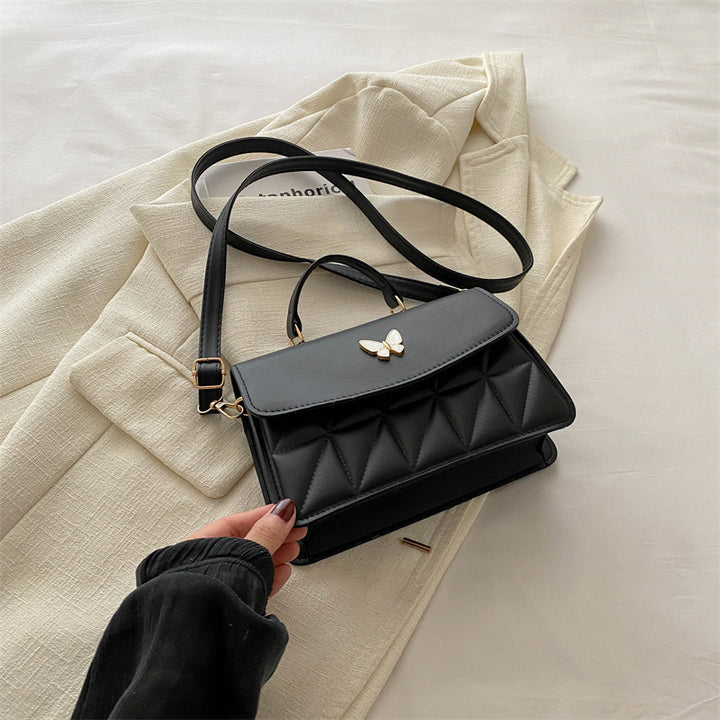 Damen elegante Handtasche mit Quermuster und stylischem Schmetterling Nord Taschen