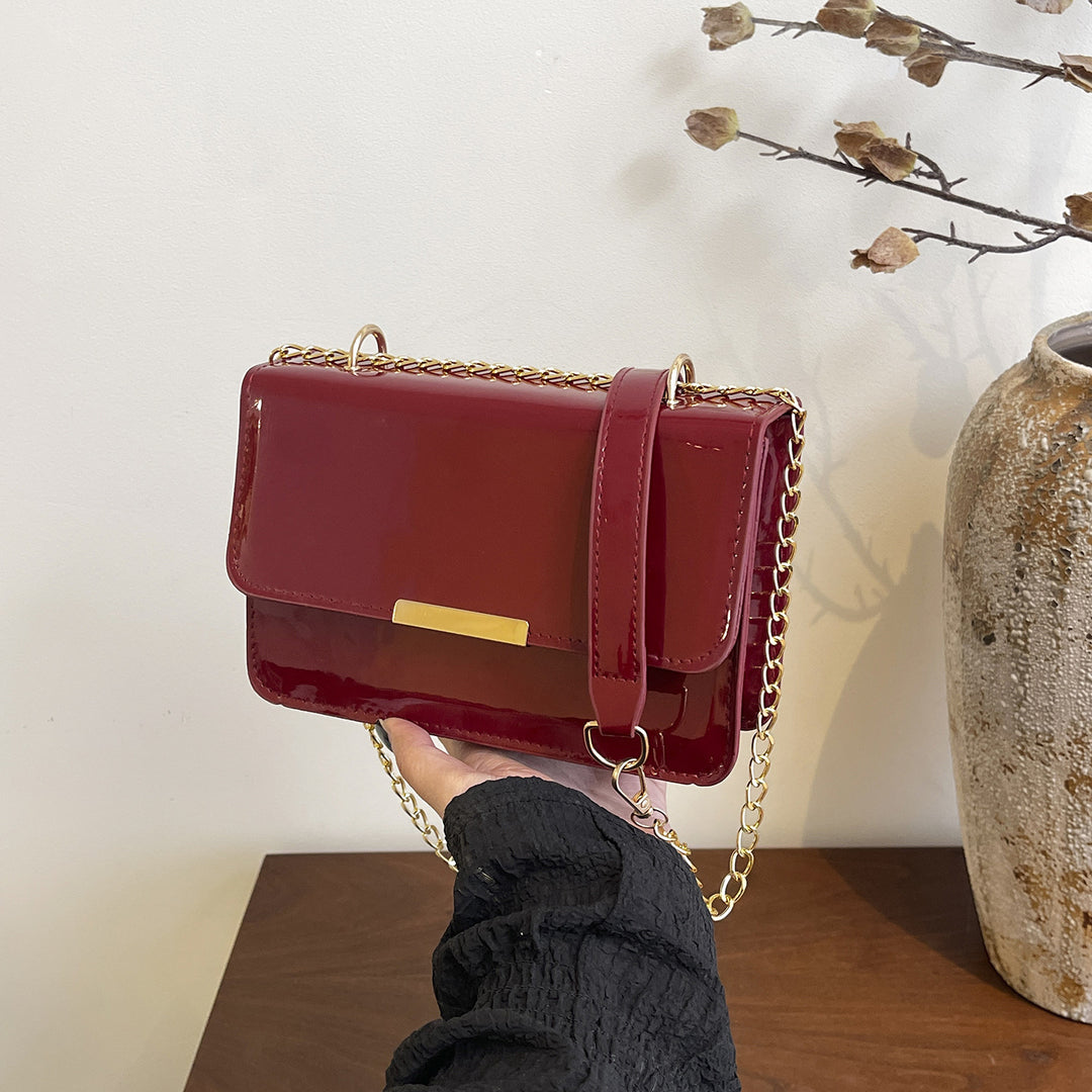 Damen elegante Umhängetasche mit glänzender Oberfläche und goldenen Akzenten Nord Taschen