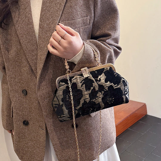 Damen stilvolle Handtasche mit floralem Design und goldfarbenen Akzenten Nord Taschen