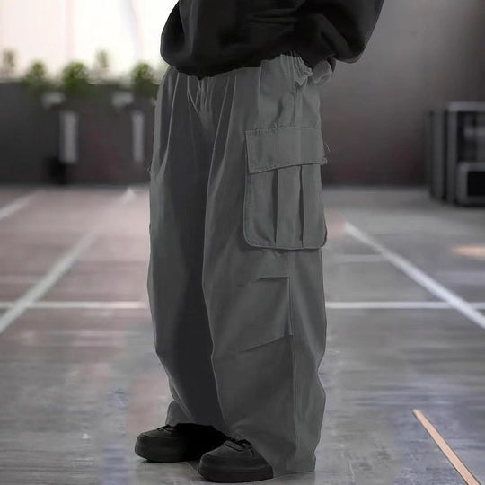Herren Oversize-Baggy-Cargohose im Urban-Utility-Stil mit elastischem Tunnelzugbund und Mehrfachklappentaschen Nord Taschen