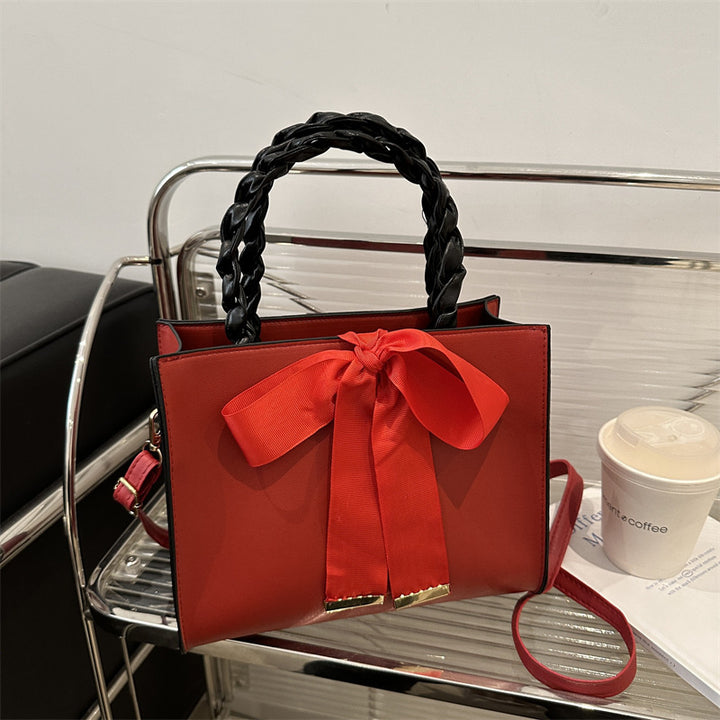 Damen elegante Handtasche mit geflochtenem Ledergriff und Schleifenakzent Nord Taschen