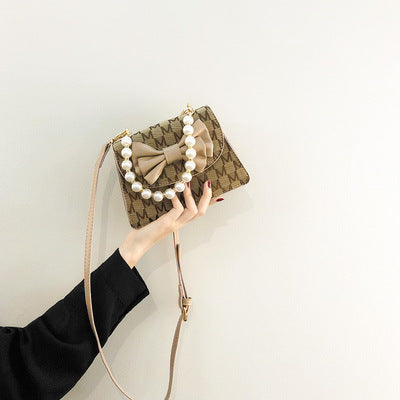 Damen Clutch mit verspieltem Schleifen-Design und edlen Perlenakzenten Nord Taschen