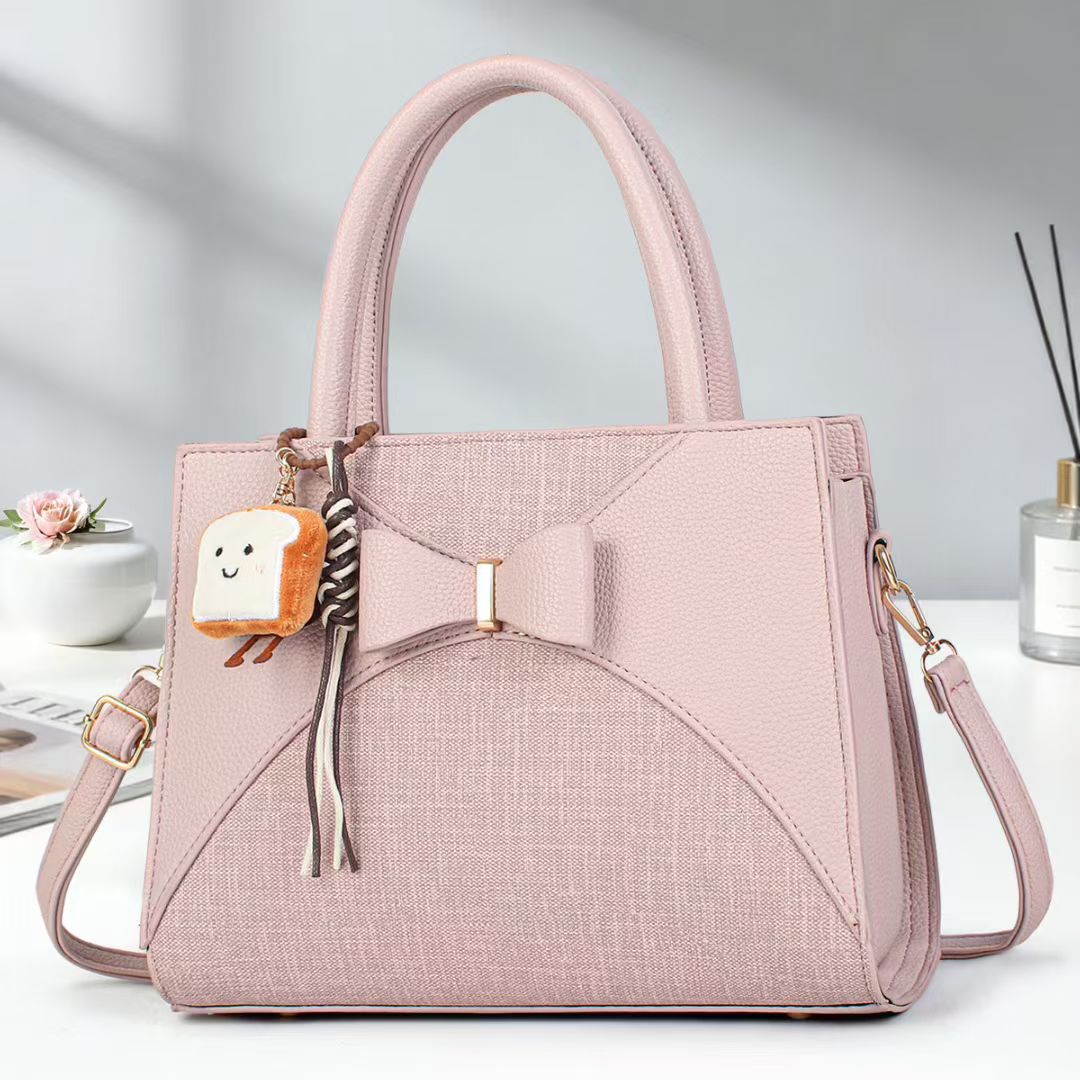 Damen elegante Handtasche mit Schleifenakzent und verspieltem Anhänger Nord Taschen