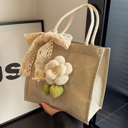 Damen Jute-Handtasche mit floralem Akzent und dekorativem Schleifenband Nord Taschen