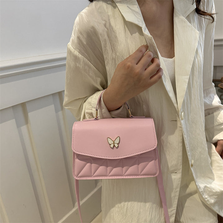 Damen elegante Handtasche mit Quermuster und stylischem Schmetterling Nord Taschen
