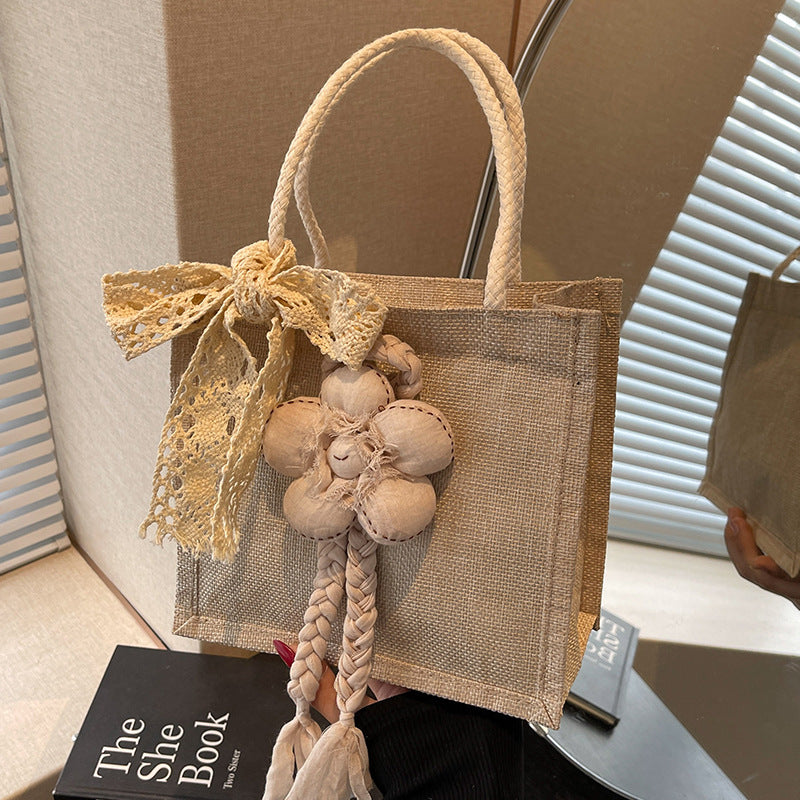 Damen Handtasche mit floralen Details und romantischem Bogen Nord Taschen