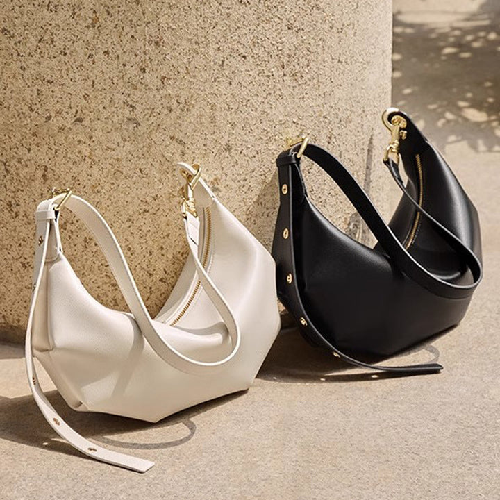 Damen Hobo-Tasche mit modernem, geschwungenem Design und goldenen Akzenten Nord Taschen