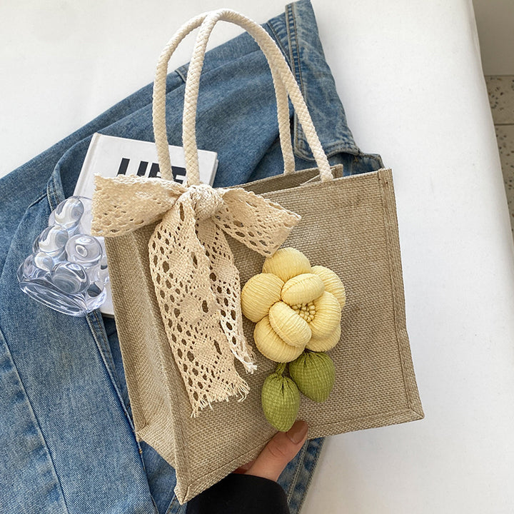 Damen Jute-Handtasche mit floralem Akzent und dekorativem Schleifenband Nord Taschen