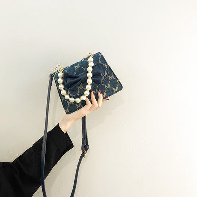 Damen Clutch mit verspieltem Schleifen-Design und edlen Perlenakzenten Nord Taschen