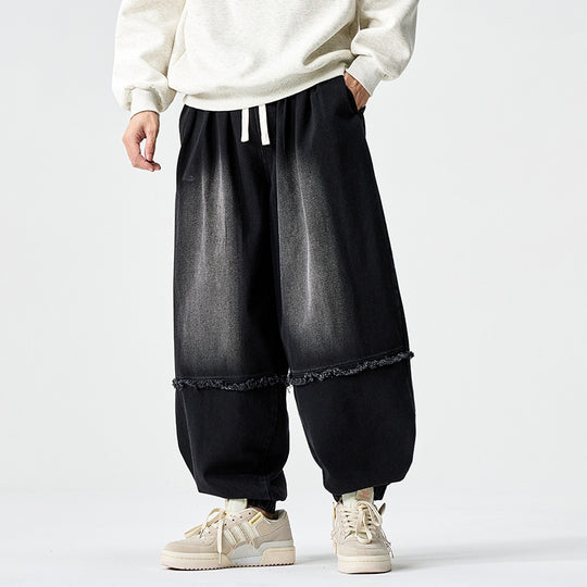 Herren Weit geschnittene Baggy-Denim-Hose mit Tunnelzug, elastischen Beinabschlüssen und Fransen-Detail Nord Taschen