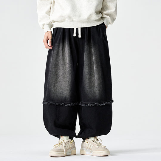 Herren Weit geschnittene Baggy-Denim-Hose mit Tunnelzug, elastischen Beinabschlüssen und Fransen-Detail Nord Taschen