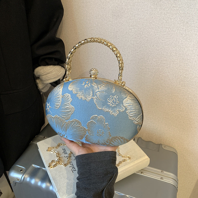 Damen Clutch mit floralem Muster und goldenen Akzenten Nord Taschen