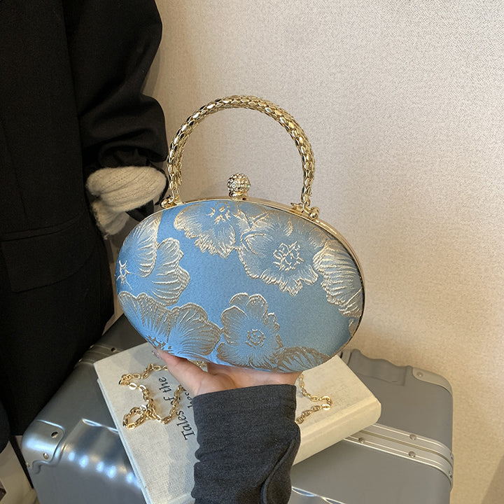 Damen Clutch mit floralem Muster und goldenen Akzenten Nord Taschen