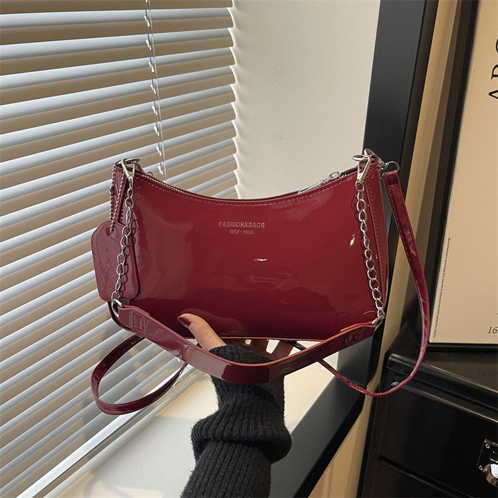 Damen elegante Umhängetasche mit glänzender Lackoberfläche Nord Taschen