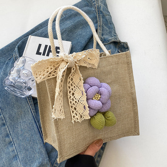 Damen Jute-Handtasche mit floralem Akzent und dekorativem Schleifenband Nord Taschen