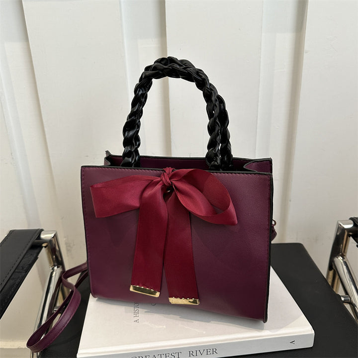 Damen elegante Handtasche mit geflochtenem Ledergriff und Schleifenakzent Nord Taschen