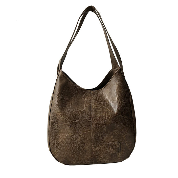 Damen Handtasche mit geschwungenem Design und hochwertiger Lederstruktur Nord Taschen