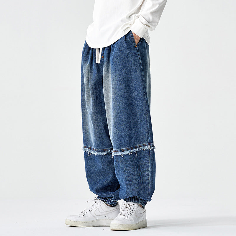 Herren Weit geschnittene Baggy-Denim-Hose mit Tunnelzug, elastischen Beinabschlüssen und Fransen-Detail Nord Taschen