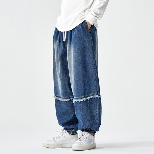 Herren Weit geschnittene Baggy-Denim-Hose mit Tunnelzug, elastischen Beinabschlüssen und Fransen-Detail Nord Taschen