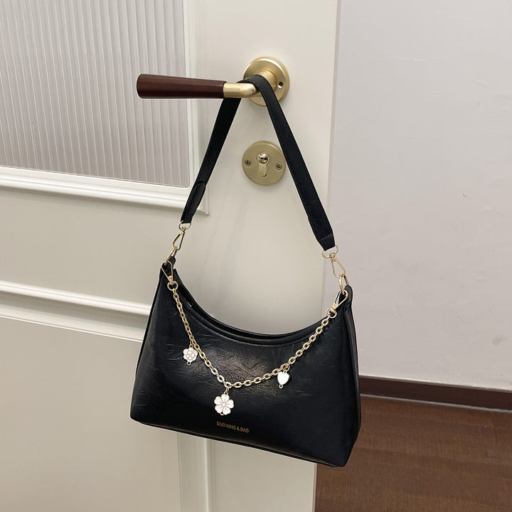 Damen Umhängetasche mit elegantem Ketten-Design und floralem Akzent Nord Taschen