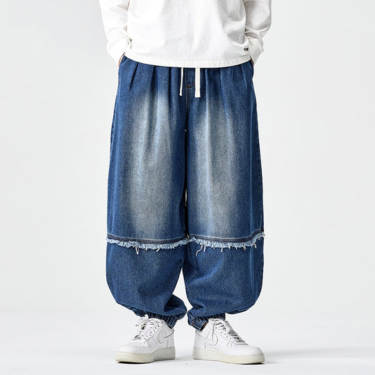 Herren Weit geschnittene Baggy-Denim-Hose mit Tunnelzug, elastischen Beinabschlüssen und Fransen-Detail Nord Taschen