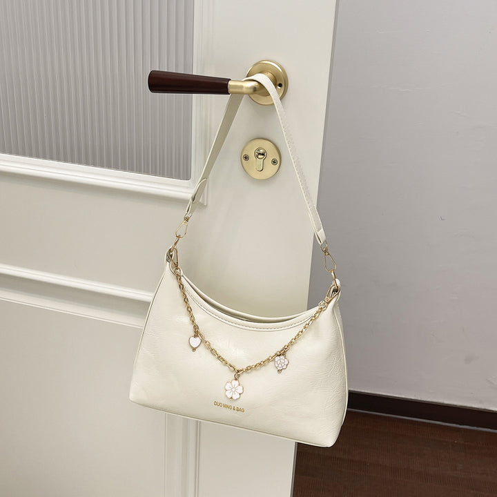 Damen Umhängetasche mit elegantem Ketten-Design und floralem Akzent Nord Taschen