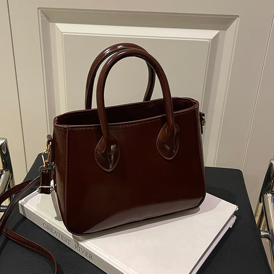 Damen elegante Handtasche aus glänzendem Kunstleder Nord Taschen
