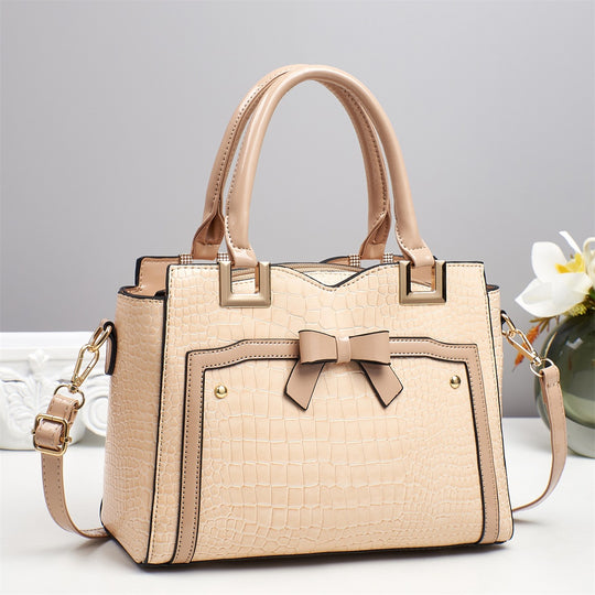 Damen elegante Handtasche mit dekorativem Schleifen-Detail und strukturiertem Krokodil-Leder-Look Nord Taschen