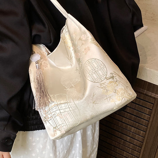 Damen Hobo-Tasche mit elegantem floralem Design und dekorativem Quastenanhänger Nord Taschen