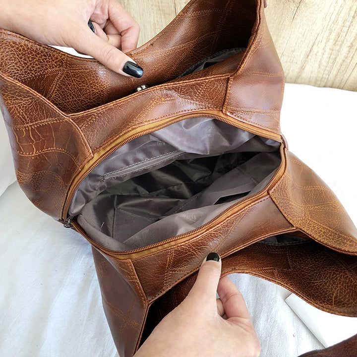 Damen Handtasche mit geschwungenem Design und hochwertiger Lederstruktur Nord Taschen