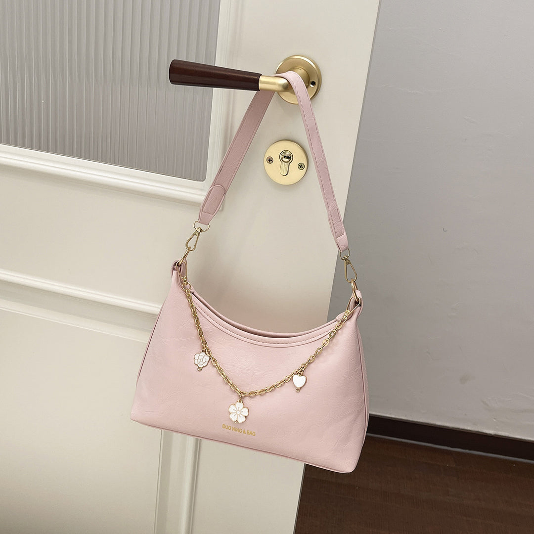 Damen Umhängetasche mit elegantem Ketten-Design und floralem Akzent Nord Taschen
