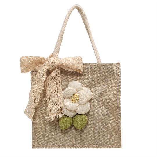 Damen Jute-Handtasche mit floralem Akzent und dekorativem Schleifenband Nord Taschen