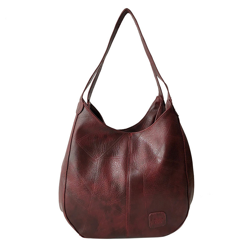 Damen Handtasche mit geschwungenem Design und hochwertiger Lederstruktur Nord Taschen