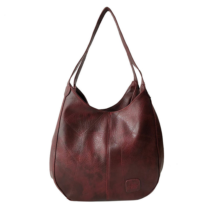 Damen Handtasche mit geschwungenem Design und hochwertiger Lederstruktur Nord Taschen