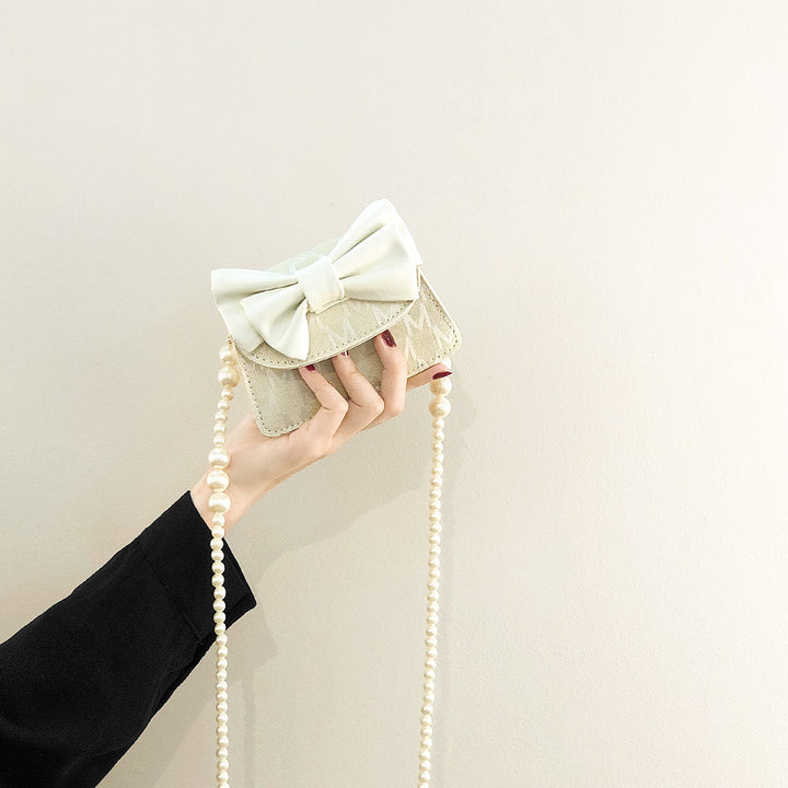 Damen Clutch mit verspieltem Schleifen-Design und edlen Perlenakzenten Nord Taschen