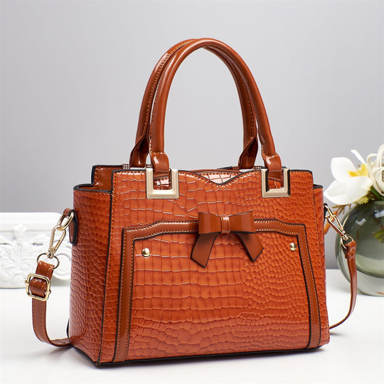 Damen elegante Handtasche mit dekorativem Schleifen-Detail und strukturiertem Krokodil-Leder-Look Nord Taschen