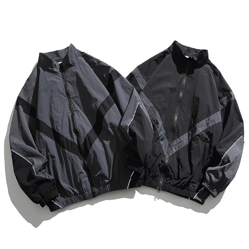 [Unisex] Oversize technische Wind- und Regenjacke mit Stehkragen, reflektierenden Paspeln und elastischem Saum Nord Taschen