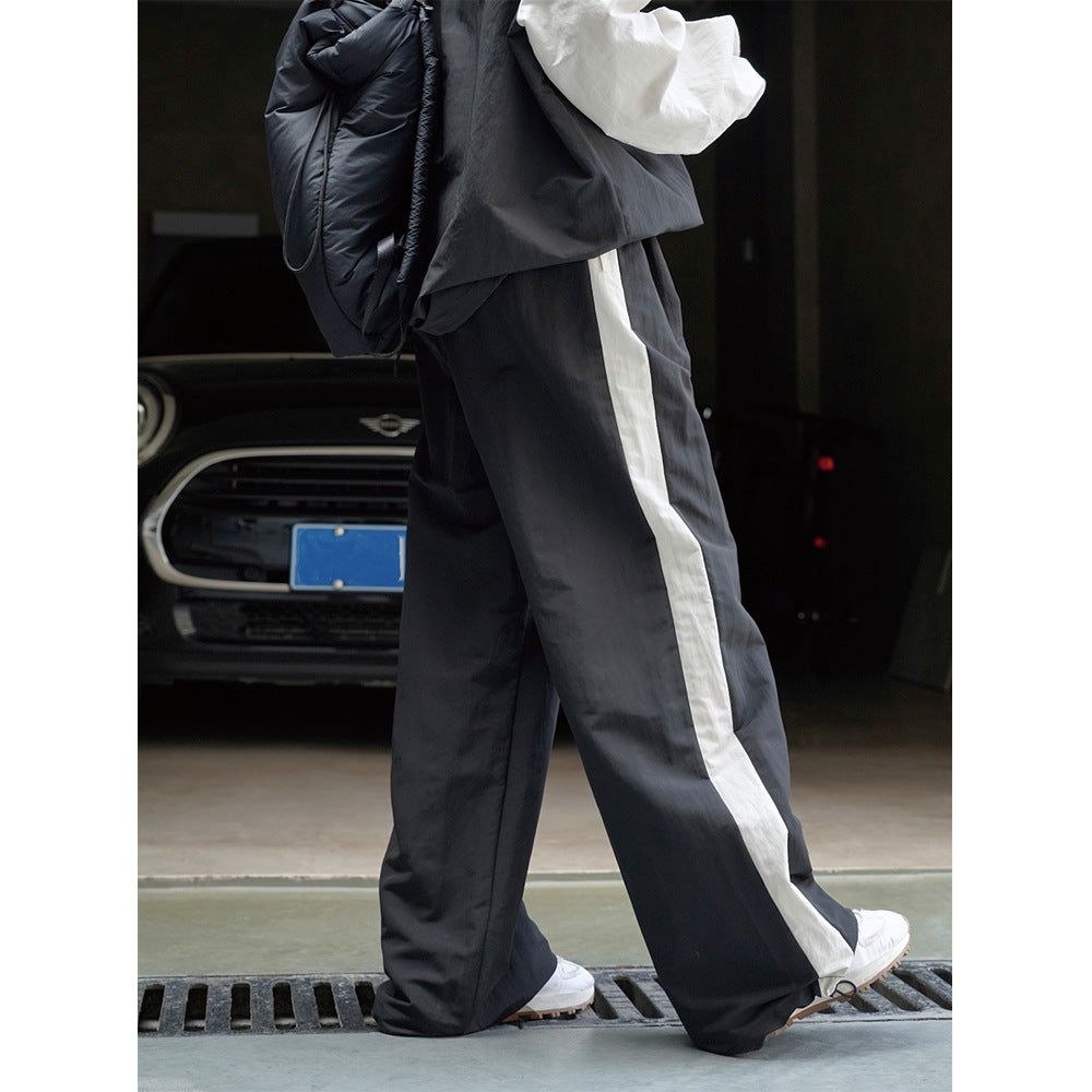 Damen Weite High‑Waist Trackhose im Palazzoschnitt mit kontrastierendem Seitenstreifen Nord Taschen