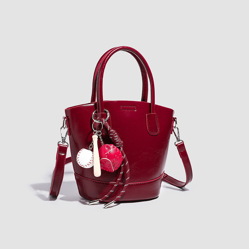 Damen Mini-Tasche mit glänzender Oberfläche und verspieltem Anhänger Nord Taschen