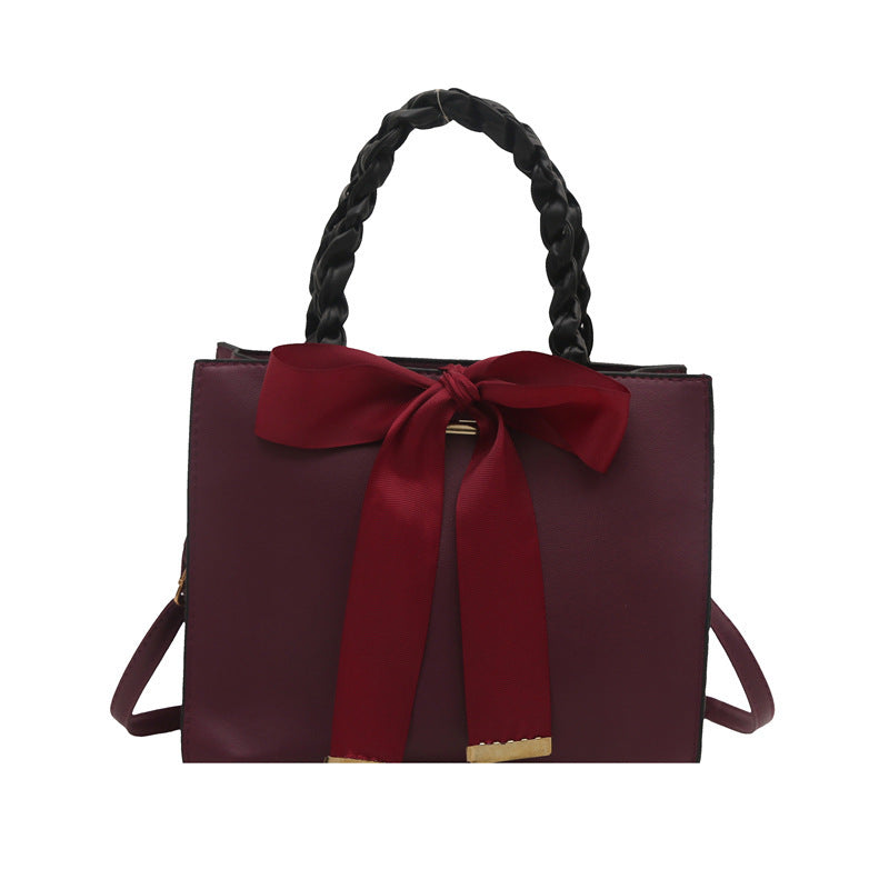 Damen elegante Handtasche mit geflochtenem Ledergriff und Schleifenakzent Nord Taschen
