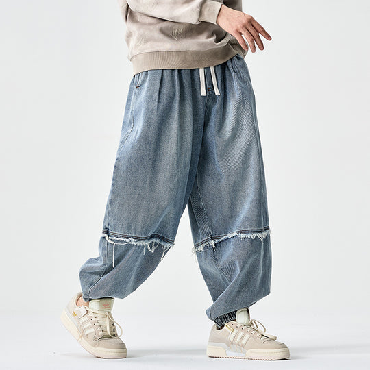 Herren Weit geschnittene Baggy-Denim-Hose mit Tunnelzug, elastischen Beinabschlüssen und Fransen-Detail Nord Taschen