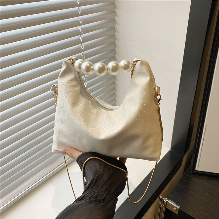 Damen Umhängetasche mit Perlenhenkel und eleganter Schlangenprägung Nord Taschen