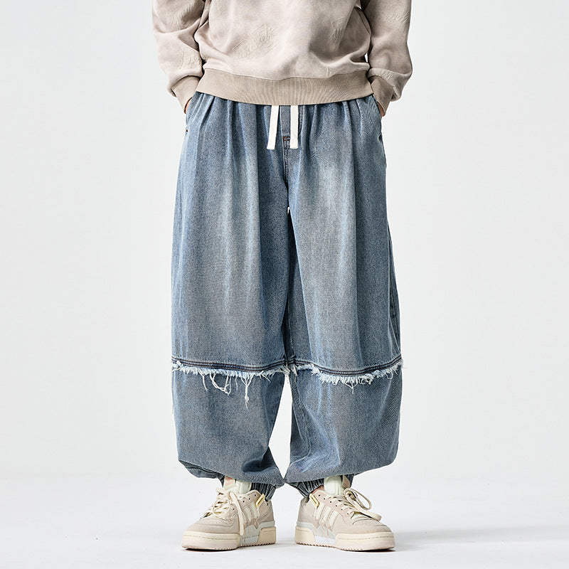 Herren Weit geschnittene Baggy-Denim-Hose mit Tunnelzug, elastischen Beinabschlüssen und Fransen-Detail Nord Taschen