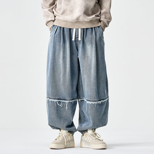 Herren Weit geschnittene Baggy-Denim-Hose mit Tunnelzug, elastischen Beinabschlüssen und Fransen-Detail Nord Taschen