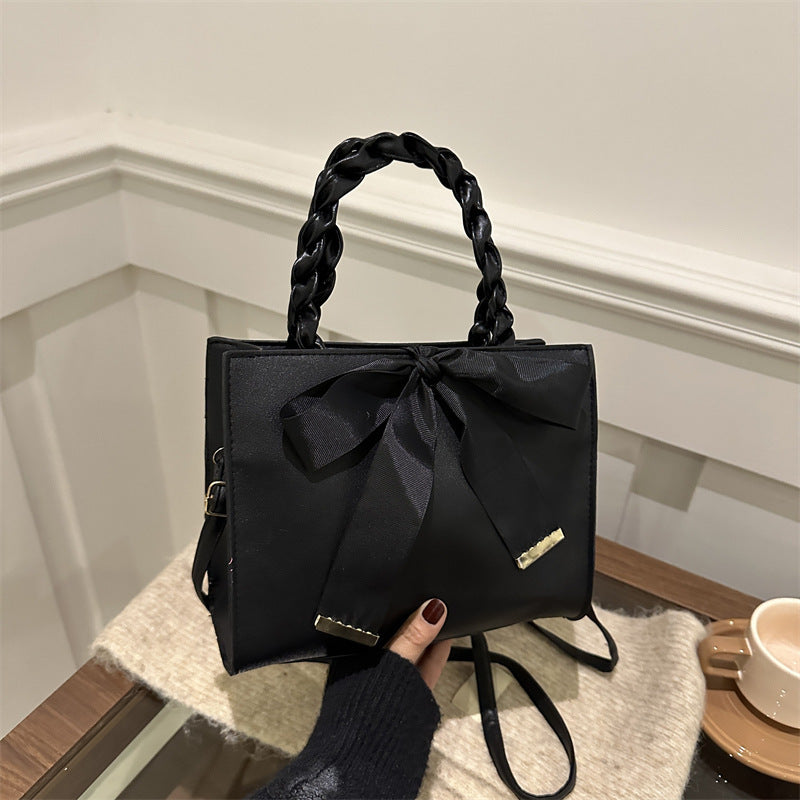 Damen elegante Handtasche mit geflochtenem Ledergriff und Schleifenakzent Nord Taschen