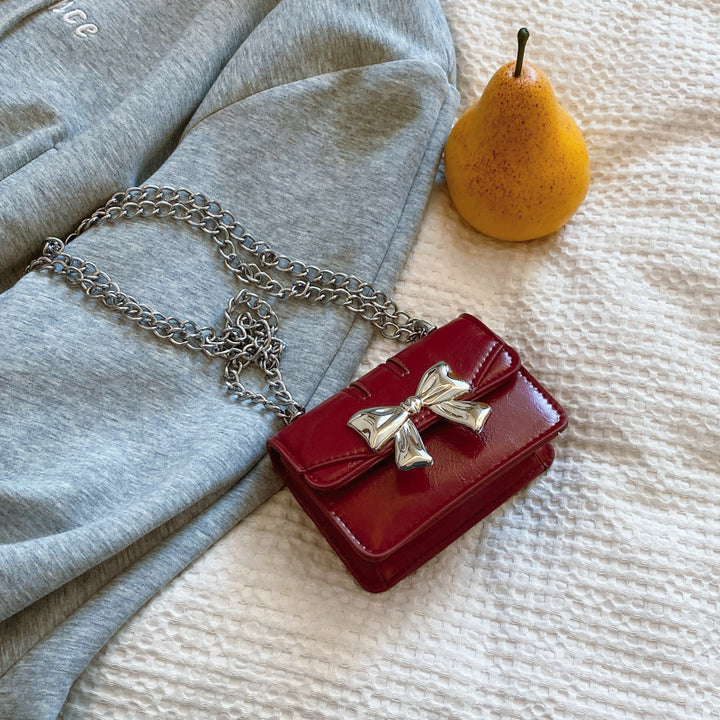 Damen Mini-Handtasche mit schimmerndem Schleifenverschluss Nord Taschen
