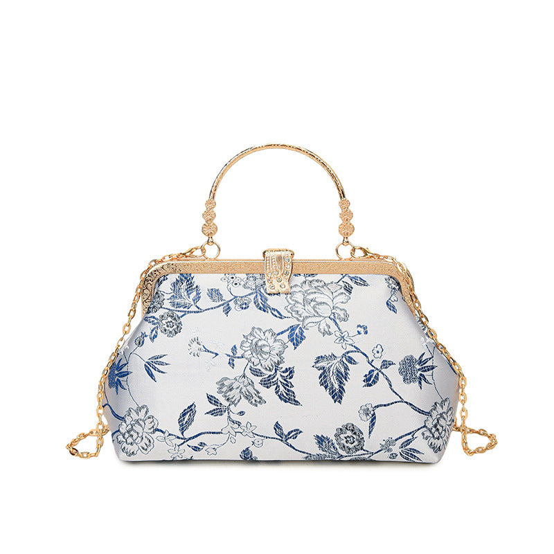 Damen stilvolle Handtasche mit floralem Design und goldfarbenen Akzenten Nord Taschen