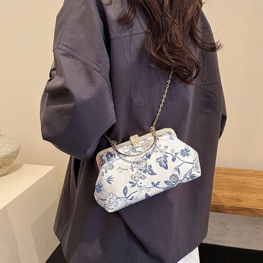 Damen stilvolle Handtasche mit floralem Design und goldfarbenen Akzenten Nord Taschen