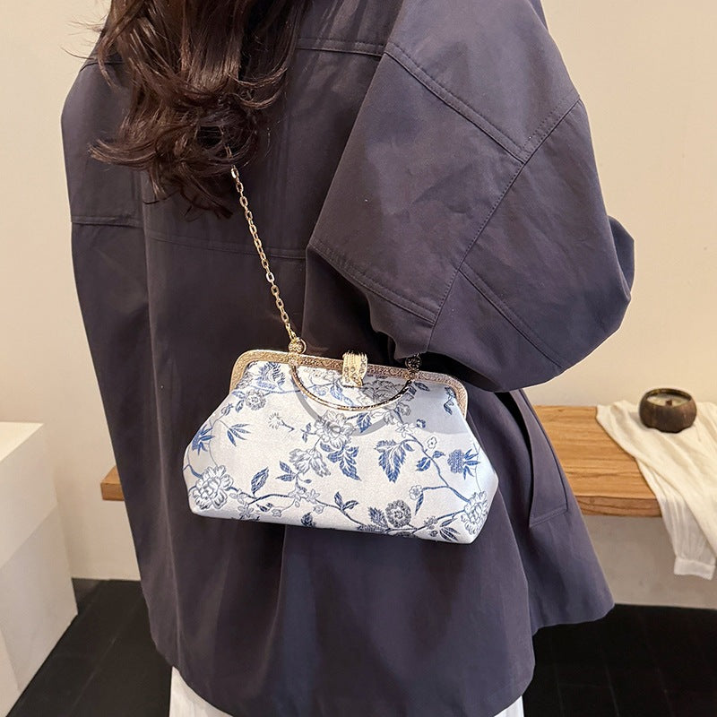 Damen stilvolle Handtasche mit floralem Design und goldfarbenen Akzenten Nord Taschen